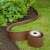 Nature brown garden edging installed, curved shape, with roll