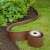 Nature brown garden edging installed, curved shape, with roll