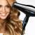 Woman with long blonde hair using a black hair dryer
