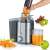 Severin ES3566 stainless steel juicer with a glass of orange juice, carrots and apples