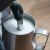 Close-up of Sage SES880BSS milk frother wand in a pitcher