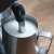Close-up of Sage SES880BSS milk frother wand in a pitcher