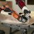 Black and Decker cordless angle grinder cutting tile on a workbench