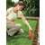 Black+Decker GSL200-QW 3.6V Cordless Grass Trimmer being used by a woman to trim grass