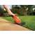 Black+Decker GSL200-QW 3.6V Cordless Grass Trimmer trimming grass along a sidewalk