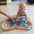 Baby playing with BabyOno Coral Reef water play mat