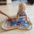 Baby playing with BabyOno Coral Reef water play mat