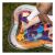 Baby playing on BabyOno Coral Reef inflatable water mat outdoors