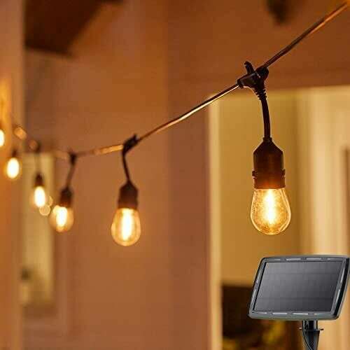 Solar powered string lights with warm white bulbs, perfect for outdoor decoration