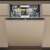 Whirlpool W8I HT58 TS built-in dishwasher, beige, open door, showing interior
