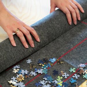 Rolling up a puzzle on a Trefl Roll & Store Puzzle Mat - Trefl Puzzle