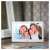 Sencor SDF742WE 7 inch digital photo frame, white, on a wooden table