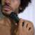Man using BaByliss 10-in-1 Multigroomer MT728E to trim his beard