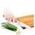 Lamart bamboo cutting board with knife sharpener, person using the board to cut vegetables