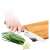 Lamart bamboo cutting board with knife sharpener, person using the board to cut vegetables