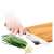 Lamart bamboo cutting board with knife sharpener, person using the board to cut vegetables