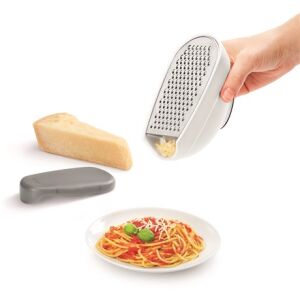 Metaltex Trio-box grater in use grating cheese over pasta - Handheld slicer