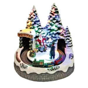 Christmas village with Santa Claus, children, and a train, illuminated with LED lights - Christmas Decoration