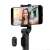 Xiaomi Mi Selfie Stick Tripod, czarny, w użyciu ze smartfonem, pokazujący pilot Bluetooth