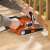 Black+Decker KA88 belt sander in use, sanding wood deck