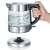 Severin WK 3468 1.0L glass kettle with water inside and hand holding the handle, base is shown separately