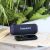 Tronsmart T7 Lite blue speaker on wooden surface with smartphone