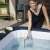 Woman cleaning the inflatable hot tub with the Bestway Lay-Z-Spa scoop