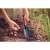 Person using Fiskars Ergo Transplanter to plant bulbs in the garden
