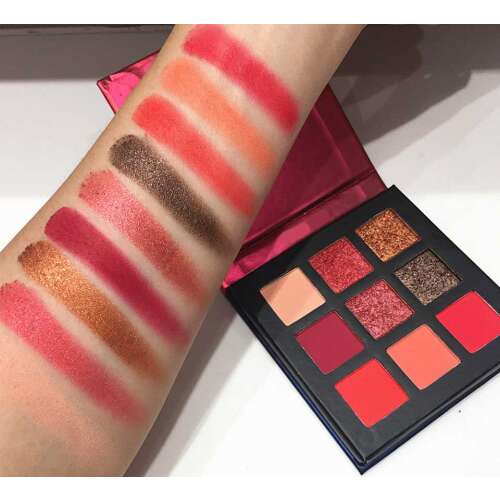 Technic Intrigued Pressed Pigment Palette, 9 shades of red, pink, and brown eyeshadows, swatches on skin
