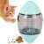 Cat playing with interactive treat dispensing toy, egg shaped, clear plastic with green lid, cat is orange and white