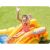 Child sliding down the Intex Dinosaur Play Center inflatable water slide