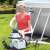 Woman setting up Intex KrystalSand sand filter pump for above ground pool