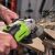 Greenworks GD24AG cordless angle grinder in action, grinding metal