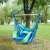 Pepita single hanging chair with cushions, blue and green striped, in use in a garden