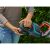 Person inserting battery into Gardena ComfortCut 60/18V hedge trimmer