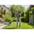Man using Gardena ComfortCut P4A 23/18V Cordless Grass Trimmer to trim grass around a garden