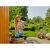 Woman using Gardena cordless barrel pump to water garden