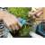 Woman using Gardena 8707-20 Balcony Pruning Shears to trim flowers