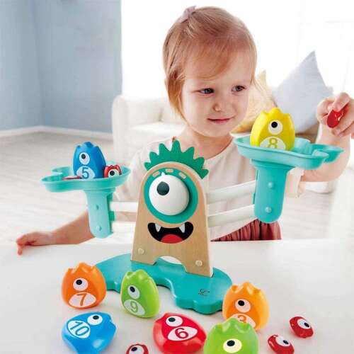 Child playing with Hape Monster Balance Scale educational toy