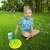 Child playing with FruBlu Soap Bubbles Tree Set, giant bubble wand with 12 rings and 0.4l bubble solution