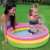 Child playing in Intex Sunset Glow inflatable kiddie pool, pink, yellow, blue, 86cm diameter