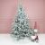 Christmas tree decorated with pink and blue Springos ornaments in a room setting