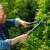 Man using Gardena EasyCut Hedge Trimming Shears to trim a hedge
