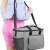 Woman carrying Springos thermal bag with shoulder strap, back view