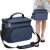 Springos thermal bag, blue, with shoulder strap and handle, two zippered compartments, side mesh pocket, woman carrying the bag