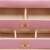 Springos jewelry box, pink, with gold accents, open, showing interior compartments and drawers, close-up