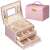 Springos jewelry box, pink, with gold accents, open, showing interior compartments and drawers, filled with jewelry