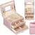 Springos jewelry box, pink, with gold accents, open, showing interior compartments and drawers, filled with jewelry, collage