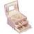 Springos jewelry box, pink, with gold accents, open, showing interior compartments and drawers, filled with jewelry