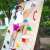 Child climbing a wall with Springos climbing holds in a backyard